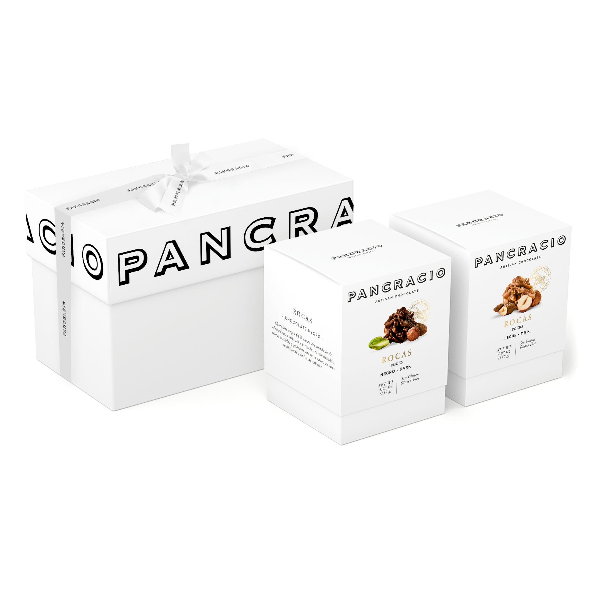 Una caja de regalo, junto a dos cajas pequeñas de bombones de dos sabores distintos.